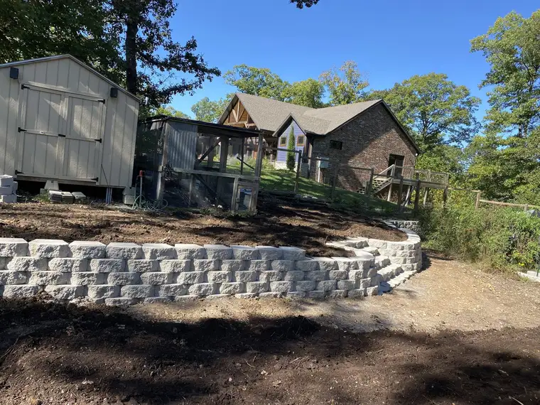 Block retaining wall across a backyard slope, Nixa, MO