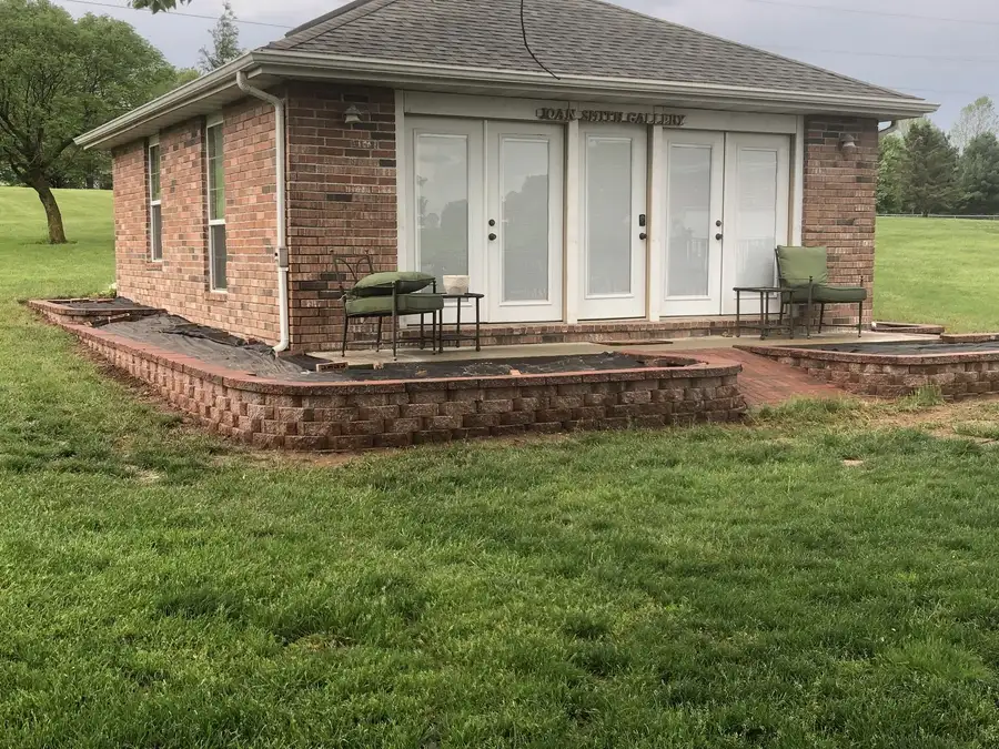 Brick patio and planters around a house, Ozark, MO