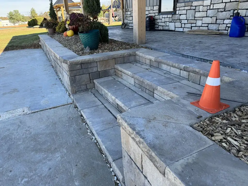 Stone steps and a raised stone planter wall, one of our jobs